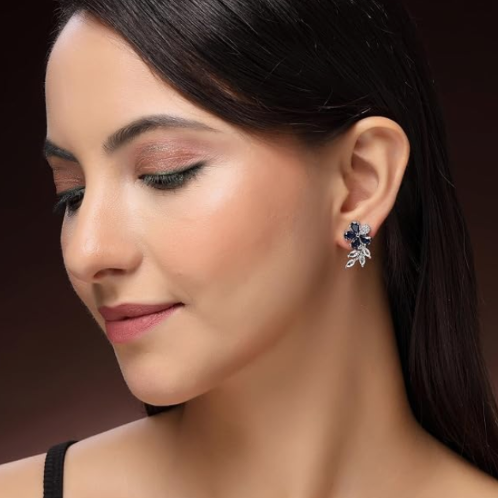 Zeneme Rhodium Plated Silver Toned Floral Shaped American Diamond Studded Stud Earrings For Women & Girls